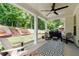 Covered back porch with ceiling fan and comfortable seating area at 197 Stafford Ln, Villa Rica, GA 30180