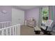 Bedroom with crib, dresser, and rocking chair at 197 Stafford Ln, Villa Rica, GA 30180