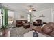 Comfortable living room with leather sofas, hardwood floors, and a ceiling fan at 197 Stafford Ln, Villa Rica, GA 30180