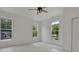 Bright bedroom featuring two large windows and ceiling fan at 995 Whitehead Rd, Sugar Hill, GA 30518