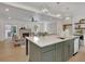 Open concept kitchen with an island, looking into the living room with fireplace at 995 Whitehead Rd, Sugar Hill, GA 30518