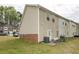 Exterior view shows the back of the house with a patio and grill at 556 Maggie Ln, Jonesboro, GA 30238