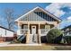 Charming craftsman bungalow with gray siding, front porch, and landscaped yard at 1078 Hobson Sw St, Atlanta, GA 30310