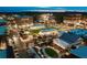 Night-time aerial view of a charming town square with illuminated buildings and landscaping at 625 Mayfair Ct, Alpharetta, GA 30009