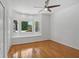 Spacious bedroom with hardwood floors, a bay window and ceiling fan at 1674 Rocky Top Sw Dr, Lilburn, GA 30047