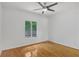 Bedroom with hardwood floors, ceiling fan and large window at 1674 Rocky Top Sw Dr, Lilburn, GA 30047