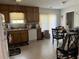 Kitchen with wood cabinets, a dishwasher, and a dining area at 6801 Red Maple Dr, Rex, GA 30273