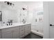 Bathroom with double vanity, modern lighting, and a glass shower at 130 2Nd Se Ave, Atlanta, GA 30317