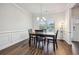 Dining room with hardwood floors, wainscoting, and a chandelier at 1007 Alcovy River Ct, Loganville, GA 30052