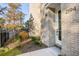 Landscaped front yard with mature trees and modern entrance at 2194 Bristol Cove # 13, Chamblee, GA 30341