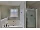 Bathroom with soaking tub, shower, and quartz vanity at 101 Hickory Leaf Ln, Acworth, GA 30101