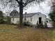 Rear view of house with yard and mature trees at 6848 Church St, Lithonia, GA 30058