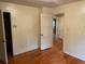 Bedroom with hardwood floors and access to bathroom at 6848 Church St, Lithonia, GA 30058