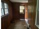 Small pantry with wood paneling and tile floor at 6848 Church St, Lithonia, GA 30058