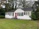 White house with red door and black shutters at 6848 Church St, Lithonia, GA 30058
