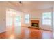 Spacious living room featuring hardwood floors and a brick fireplace at 1121 Whisper Wind Dr, Mcdonough, GA 30253