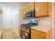 Galley kitchen with stainless steel appliances and light wood cabinets at 1121 Whisper Wind Dr, Mcdonough, GA 30253