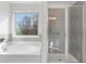 Bathroom with garden tub and walk-in shower at 3647 Lockaby Way, Lawrenceville, GA 30044