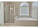 Bathroom with shower, bathtub and arched window at 401 Highway 279, Fayetteville, GA 30214