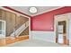 Open dining room with red walls, white wainscoting and hardwood floors at 401 Highway 279, Fayetteville, GA 30214