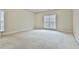 Spacious bedroom with neutral carpeting and large window at 401 Highway 279, Fayetteville, GA 30214