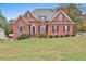 Brick house with a two-car garage and landscaped lawn at 401 Highway 279, Fayetteville, GA 30214