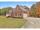 Side view of a brick house with a driveway and landscaping at 401 Highway 279, Fayetteville, GA 30214