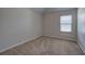 Simple bedroom with carpet, window, and neutral walls at 8728 Danley Dr, Douglasville, GA 30135