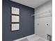 Bright laundry room with modern shelving and stylish wall art at 3621 Olive Grove Ln, Covington, GA 30016