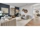 Living room with light wood floors, neutral-toned furniture, and an accent wall at 3621 Olive Grove Ln, Covington, GA 30016