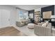 Living room with light wood floors, two armchairs, and a white door at 3621 Olive Grove Ln, Covington, GA 30016