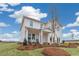 Two-story house with white siding, green door, landscaping, and a porch at 3621 Olive Grove Ln, Covington, GA 30016
