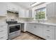 Kitchen with white cabinets and stainless steel appliances at 1143 Cedar Log Pl, Austell, GA 30168