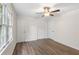 Well-lit bedroom with ceiling fan and wood-look flooring at 1143 Cedar Log Pl, Austell, GA 30168