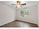 Bright bedroom with wood-look floors, ceiling fan, and window at 1143 Cedar Log Pl, Austell, GA 30168