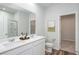 Bathroom with double vanity, walk-in shower, and linen closet at 3087 Birdsong Ave, Covington, GA 30016