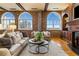 Living room with hardwood floors, exposed brick walls, and large windows at 3180 Mathieson Ne Dr # 1401, Atlanta, GA 30305