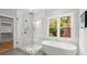 Spa-like bathroom with a large soaking tub and glass shower at 3794 Wynn Walk, Brookhaven, GA 30341