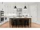 Modern kitchen features white cabinets, an island with seating, and stylish light fixtures at 3794 Wynn Walk, Brookhaven, GA 30341