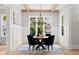 Elegant dining room with a round table, four chairs, and a statement light fixture at 3794 Wynn Walk, Brookhaven, GA 30341