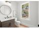 Modern bathroom with a vanity, toilet, and large window at 3794 Wynn Walk, Brookhaven, GA 30341
