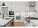 Modern kitchen with white cabinets, stainless steel appliances, and a large island at 3794 Wynn Walk, Brookhaven, GA 30341
