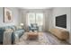 Bright living room featuring a comfy sofa and large windows at 356 Rock View Ln, Covington, GA 30016