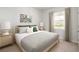 Bright bedroom with a king-size bed and striped bedding at 356 Rock View Ln, Covington, GA 30016