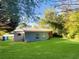 Large backyard with lush green grass and mature trees at 828 Pinevalley Dr, Forest Park, GA 30297