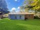 Spacious backyard with a grassy area and mature trees at 828 Pinevalley Dr, Forest Park, GA 30297