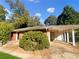 Brick ranch house with carport and landscaped yard at 828 Pinevalley Dr, Forest Park, GA 30297