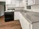 White kitchen with laminate countertops and flooring at 828 Pinevalley Dr, Forest Park, GA 30297