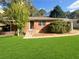 Front view of brick house with green lawn at 828 Pinevalley Dr, Forest Park, GA 30297