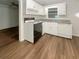Kitchen with white cabinets, laminate counters and flooring at 828 Pinevalley Dr, Forest Park, GA 30297